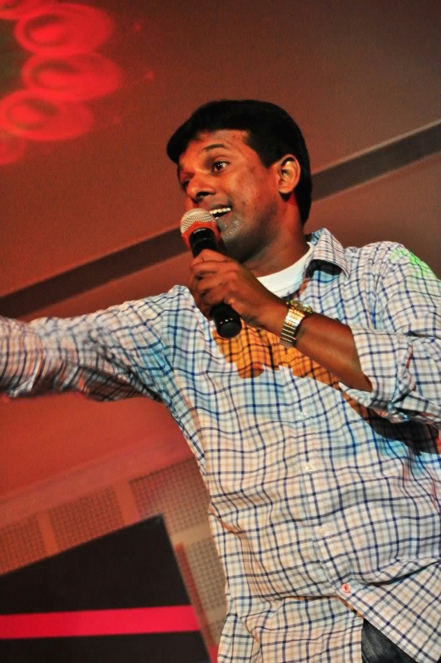 Pastor Samuel Wilson singing on stage